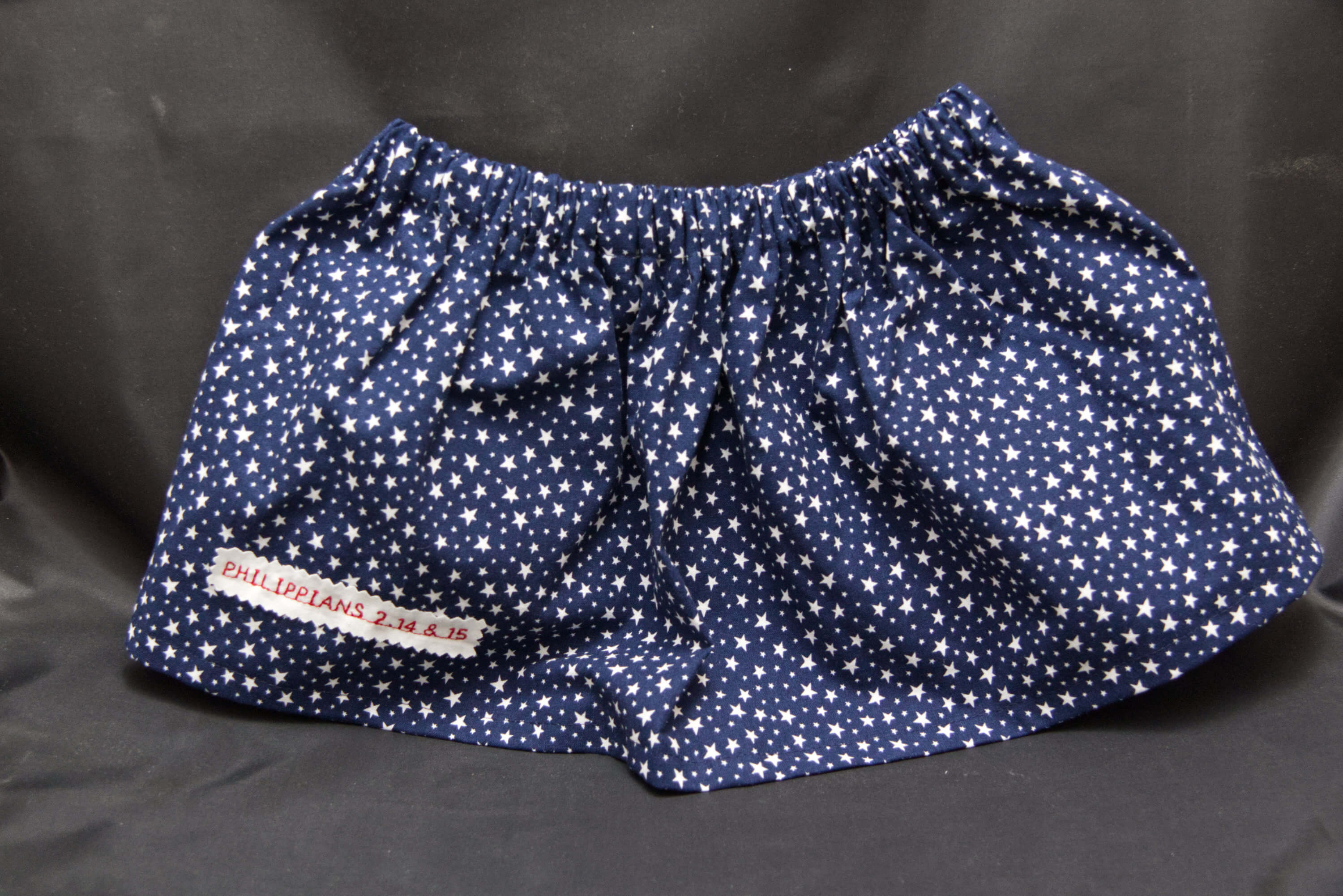A dark blue skirt with filled with small white stars.